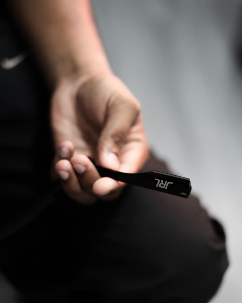Barber holding a JRL trimmer