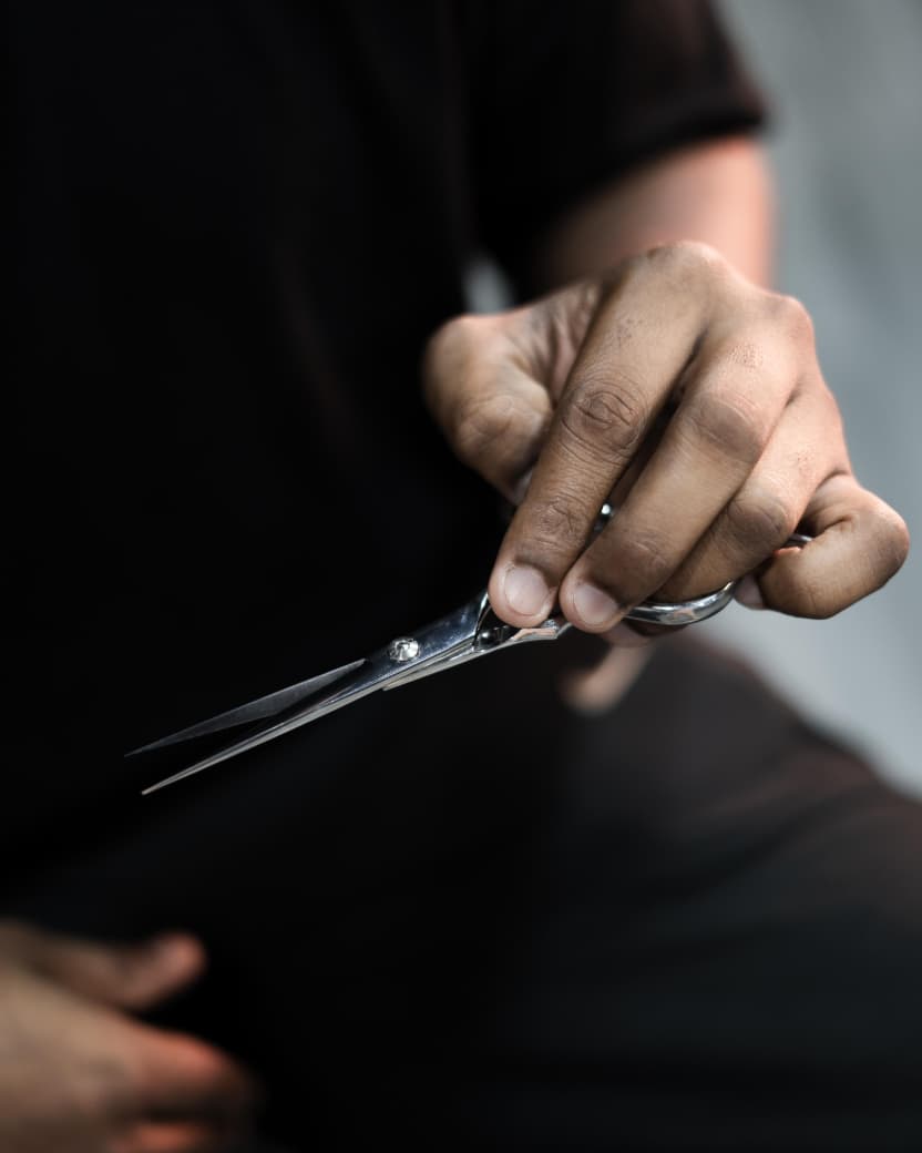 Master barber holding cutting shears